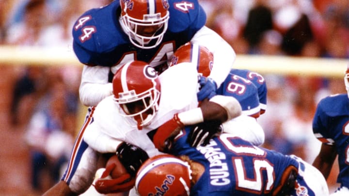 Nov. 10, 1990; Savannah, GA, USA; Gators Ephesians Bartley, #44, Darren Mickell, #92, Brad Culpepper, #50, and Huey Richardson team up to stop Georgia's Garrison Hearst, #5. Florida won 38:7; Mandatory credit: Bill Sikes-USA TODAY NETWORK via Imagn Images 