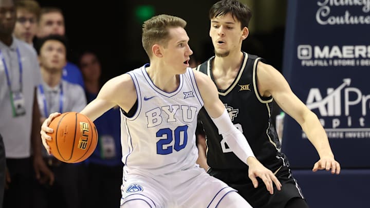 Feb 13, 2024; Provo, Utah, USA; Brigham Young Cougars guard Spencer Johnson (20) looks to pass the