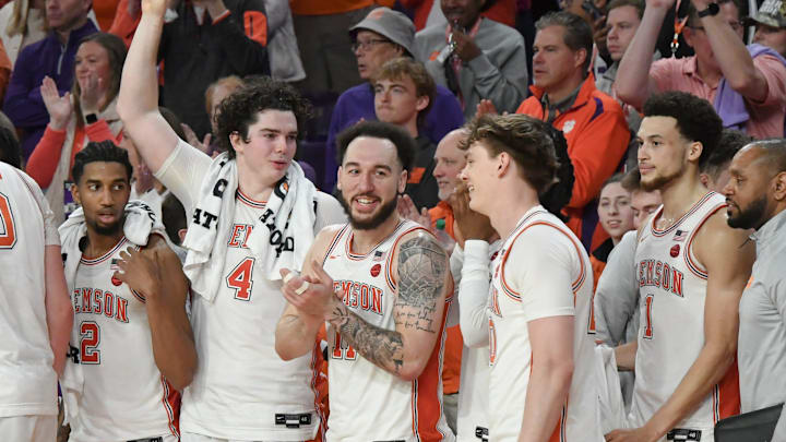 Clemson players, from left, Clemson guard Dillon Hunter (2), senior forward Ian Schieffelin (4), guard Jaeden Zackery (11) , guard Matt Kelly (20), and guard Chase Hunter (1) join in the alma mater song after Clemson beat North Carolina 85-65 Monday, Feb 10, 2025; Clemson, South Carolina, USA; at Littlejohn Coliseum.