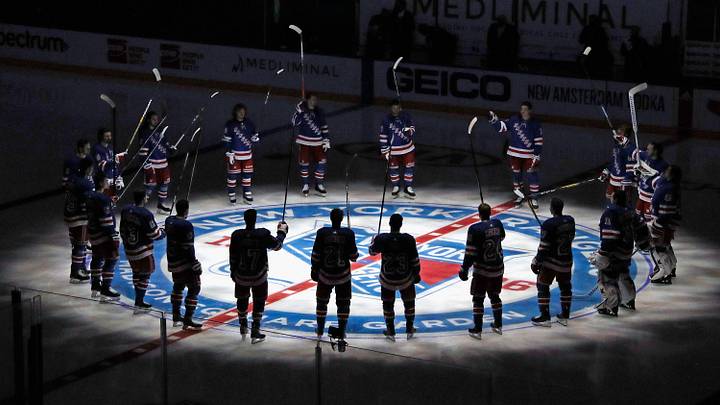 Jan 14, 2021; New York, NY, USA; New York Rangers players huddle around the center ice logo as they prepare for the home opener against the New York Islanders at Madison Square Garden. Jan 14, 2021; New York, NY, USA; New York Rangers players huddle around the center ice logo as they prepare for the home opener against the New York Islanders at Madison Square Garden.
