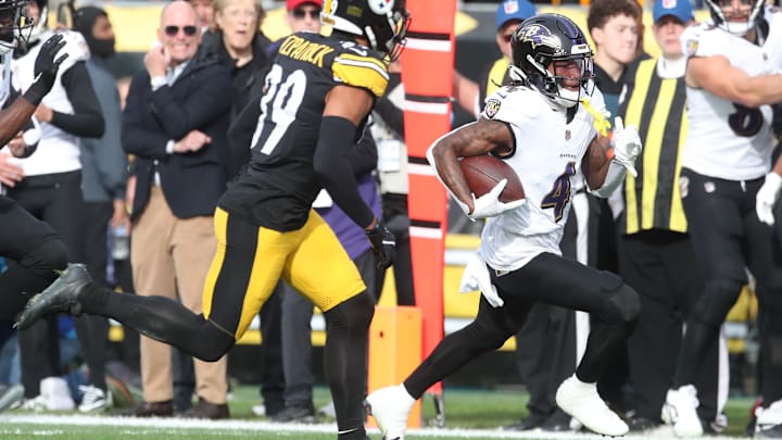 Nov 17, 2024; Pittsburgh, Pennsylvania, USA;  Baltimore Ravens wide receiver Zay Flowers (4) runs after a catch as Pittsburgh Steelers safety Minkah Fitzpatrick (39) chases during the first quarter at Acrisure Stadium. Mandatory Credit: Charles LeClaire-Imagn Images