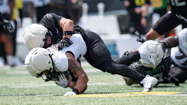 Combat Ducks inside linebacker Brayden Platt brings down Fighting Ducks running back Makhi Hughes as the Fighting Ducks face off against Mighty Oregon in the Oregon Ducks spring game on April 26, 2025, at Autzen Stadium in Eugene.
