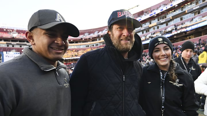 Dec 14, 2024; Landover, Maryland, USA;  Dave Portnoy poses with solders before the between the Army Black Knights and the Navy Midshipmen  at Commanders Field. Mandatory Credit: Tommy Gilligan-Imagn Images