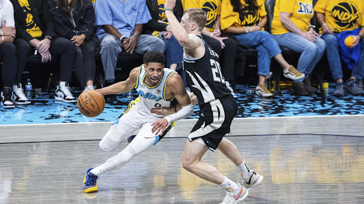 Apr 19, 2025; Indianapolis, Indiana, USA; Indiana Pacers guard Tyrese Haliburton (0) dribbles the ball while Milwaukee Bucks guard AJ Green (20) defends in the second half at Gainbridge Fieldhouse. Mandatory Credit: Trevor Ruszkowski-Imagn Images