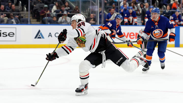 Dec 12, 2024; Elmont, New York, USA; Chicago Blackhawks center Connor Bedard (98) shoots and scores against the New York Islanders during the first period at UBS Arena. Mandatory Credit: Brad Penner-Imagn Images