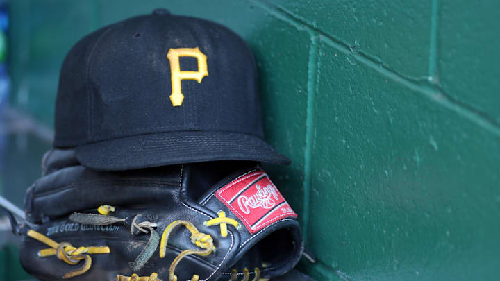 Sep 27, 2016; Pittsburgh, PA, USA;  A Pittsburgh Pirates hat and glove sit in the dugout prior to the game against the Chicago Cubs at PNC Park. Mandatory Credit: Charles LeClaire-Imagn Images