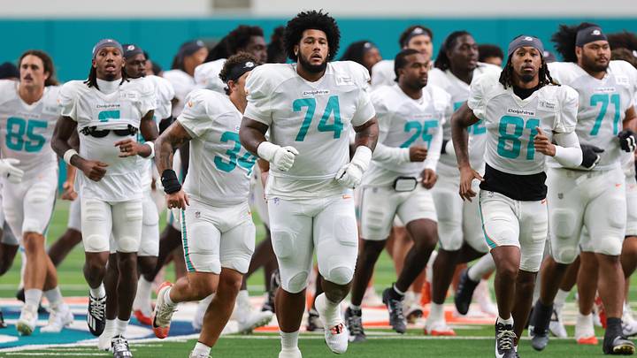 Miami Dolphins offensive lineman Kadyn Proctor (74) runs on the field during joint practice with the New York Giants at the Baptist Health Training Complex.