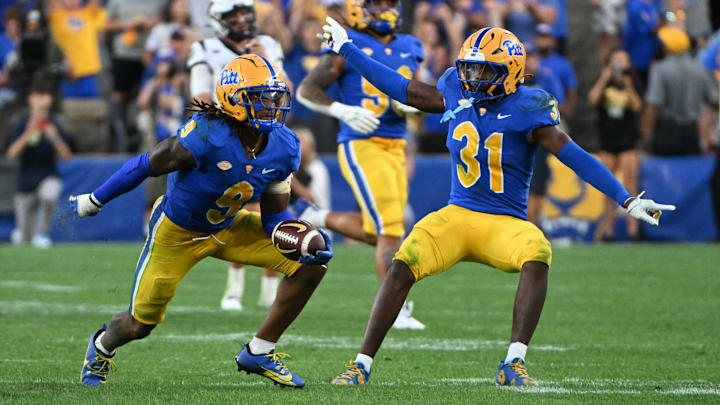 Sep 14, 2024; Pittsburgh, Pennsylvania, USA; Pittsburgh Panthers linebacker Kyle Louis celebrates with linebacker Rasheem Biles (31) after intercepting West Virginia Mountaineers quarterback Garrett Greene (6) in the fourth quarter at Acrisure Stadium. Mandatory Credit: Barry Reeger-Image Images