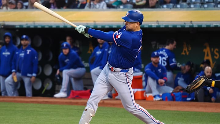 Sep 25, 2024; Oakland, California, USA; Texas Rangers first baseman Nathaniel Lowe (30) hits an RBI single against the Oakland Athletics during the first inning at Oakland-Alameda County Coliseum. 