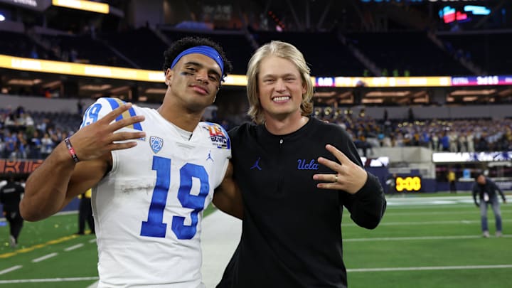 Dec 16, 2023; Inglewood, CA, USA; UCLA Bruins wide receiver coach Jerry Neuheisel (right) and wide receiver Kyle Ford (19) celebrate a victory after defeating the Boise State Broncos in the LA Bowl at SoFi Stadium. Mandatory Credit: Kiyoshi Mio-Imagn Images Dec 16, 2023; Inglewood, CA, USA; UCLA Bruins wide receiver coach Jerry Neuheisel (right) and wide receiver Kyle Ford (19) celebrate a victory after defeating the Boise State Broncos in the LA Bowl at SoFi Stadium. Mandatory Credit: Kiyoshi Mio-Imagn Images