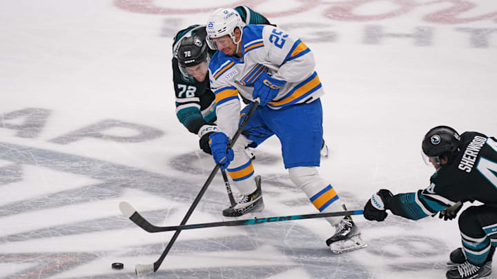 Mar 30, 2026; San Jose, California, USA;  St. Louis Blues right winger Jordan Kyrou (25) controls the puck between San Jose Sharks left wing William Eklund (72) and left wing Kiefer Sherwood (44) in the third period at SAP Center at San Jose. Mandatory Credit: David Gonzales-Imagn Images