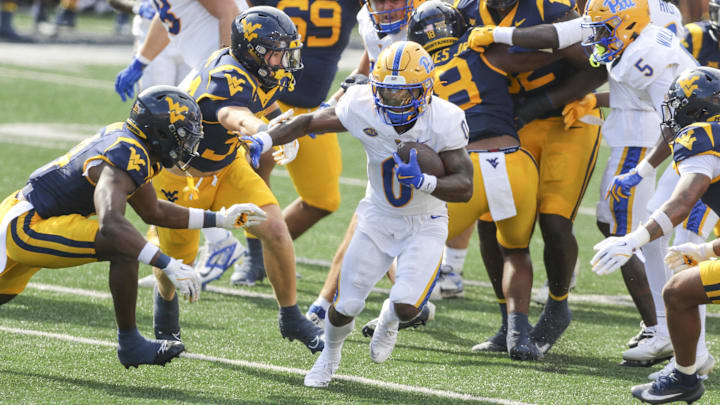 Sep 13, 2025; Morgantown, West Virginia, USA; Pittsburgh Panthers running back Desmond Reid (0) runs the ball during the first quarter against the West Virginia Mountaineers at Milan Puskar Stadium. Mandatory Credit: Ben Queen-Imagn Images Sep 13, 2025; Morgantown, West Virginia, USA; Pittsburgh Panthers running back Desmond Reid (0) runs the ball during the first quarter against the West Virginia Mountaineers at Milan Puskar Stadium. Mandatory Credit: Ben Queen-Imagn Images