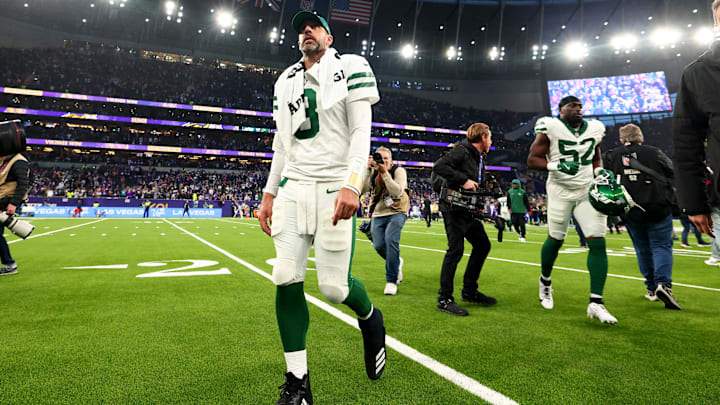 Oct 6, 2024; Tottenham, ENG; A dejected New York Jets quarterback Aaron Rodgers (8) walks back to the locker room after the 17-23 defeat to the Minnesota Vikings at Tottenham Hotspur Stadium. 