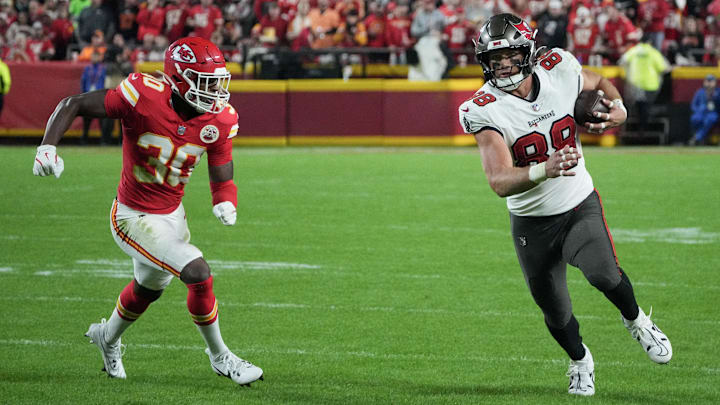 Nov 4, 2024; Kansas City, Missouri, USA; Tampa Bay Buccaneers tight end Cade Otton (88) runs the ball as Kansas City Chiefs cornerback Christian Roland-Wallace (30) chases during the second half at GEHA Field at Arrowhead Stadium. Mandatory Credit: Denny Medley-Imagn Images