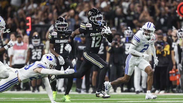 Dec 28, 2024; San Antonio, TX, USA; Colorado Buffaloes wide receiver Travis Hunter (12) runs with the ball during the second quarter against the Brigham Young Cougars at Alamodome. Mandatory Credit: Troy Taormina-Imagn Images