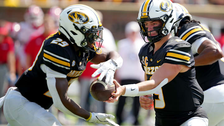 Missouri Tigers quarterback Beau Pribula (9) hands the ball off to running back Ahmad Hardy (29), in a game versus the Louisiana Ragin' Cajuns this season.