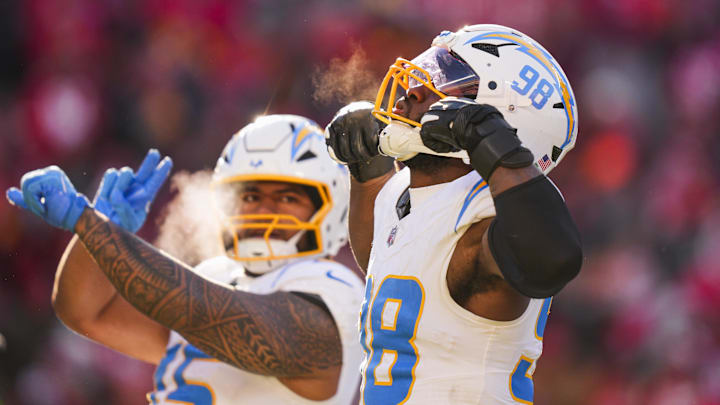Los Angeles Chargers linebacker Odafe Oweh (98) celebrates a sack against the Kansas City Chiefs during the second half at GEHA Field at Arrowhead Stadium. 