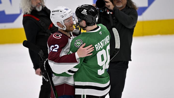 Colorado Avalanche left wing Gabriel Landeskog hugs Dallas Stars right wing Mikko Rantanen.