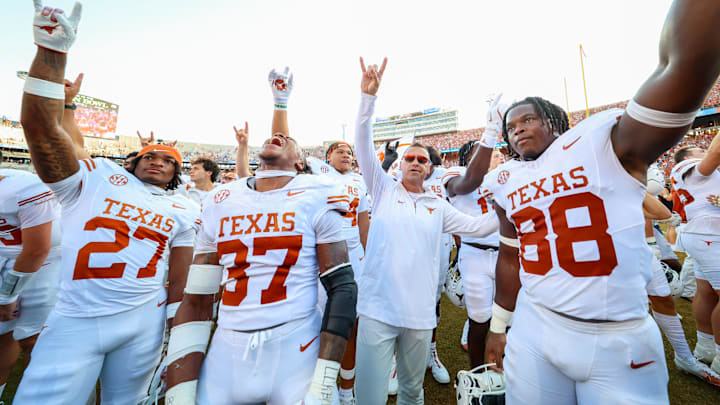 Oct 12, 2024; Dallas, Texas, USA;  Texas Longhorns linebacker Morice Blackwell Jr. (37) and Texas Longhorns linebacker Barryn Sorrell (88) and Texas Longhorns defensive back Wardell Mack (27) celebrate with head coach Steve Sarkisian after the game against the Oklahoma Sooners at the Cotton Bowl. Mandatory Credit: Kevin Jairaj-Imagn Images