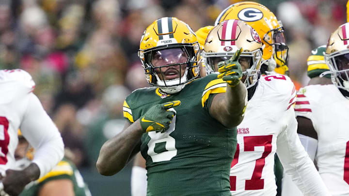 Green Bay Packers running back Josh Jacobs (8) celebrates after rushing for a first down against the 49ers.