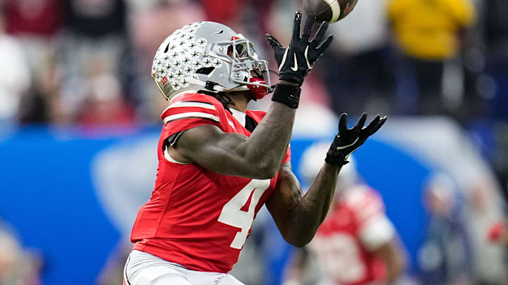Ohio State Buckeyes wide receiver Jeremiah Smith (4) catches a pass during the first half of the Big Ten Conference championship game against the Indiana Hoosiers at Lucas Oil Stadium in Indianapolis on Dec. 6, 2025. Ohio State Buckeyes wide receiver Jeremiah Smith (4) catches a pass during the first half of the Big Ten Conference championship game against the Indiana Hoosiers at Lucas Oil Stadium in Indianapolis on Dec. 6, 2025.