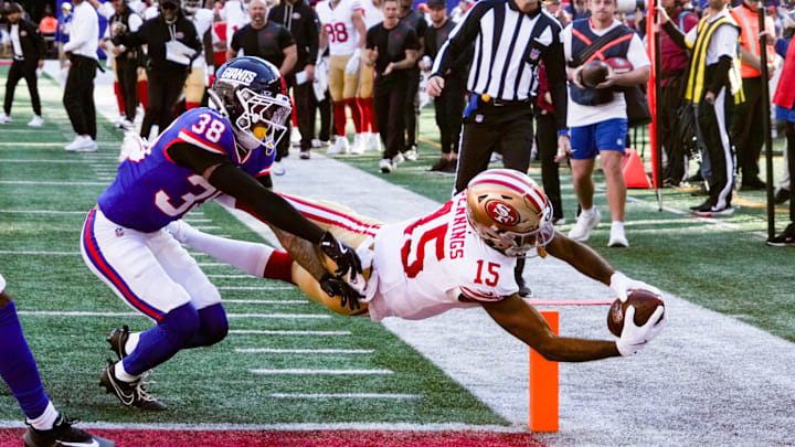 Nov 2, 2025; East Rutherford, New Jersey, USA; San Francisco 49ers wide receiver Jauan Jennings (15) dives into the endzone for a touchdown as New York Giants cornerback Korie Black (38) defends during the first half at MetLife Stadium. Mandatory Credit: Robert Deutsch-Imagn Images