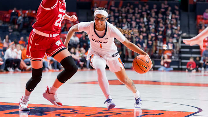 Illinois guard Aaliyah Guyton (1) drives on a Wisconsin defender in the Illini's 92-60 win over the Badgers on Wednesday at the State Farm Center in Champaign, Illinois.