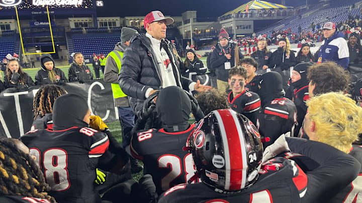 Quince Orchard head football coach addresses his team after its victory.