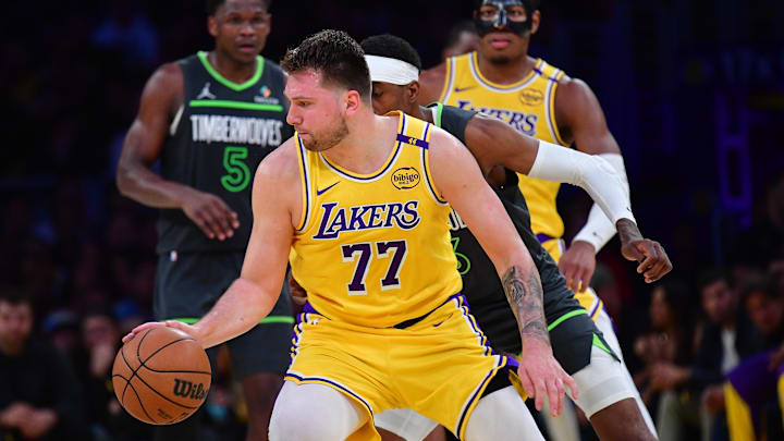 Apr 30, 2025; Los Angeles, California, USA; Los Angeles Lakers guard Luka Doncic (77) controls the ball against the Minnesota Timberwolves during the second half in game five of first round for the 2025 NBA Playoffs at Crypto.com Arena. Mandatory Credit: Gary A. Vasquez-Imagn Images