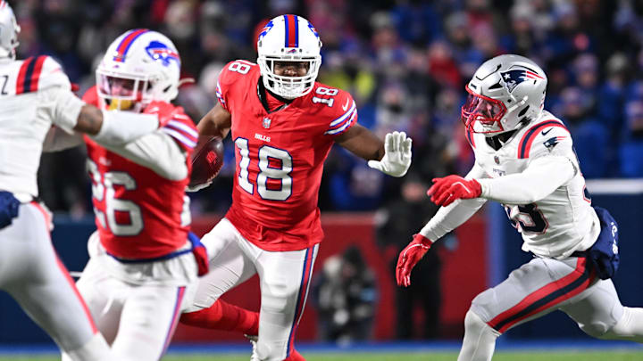 Dec 22, 2024; Orchard Park, New York, USA; Buffalo Bills wide receiver Amari Cooper (18) stiff arms New England Patriots linebacker Christian Elliss (53) in the second quarter at Highmark Stadium. 