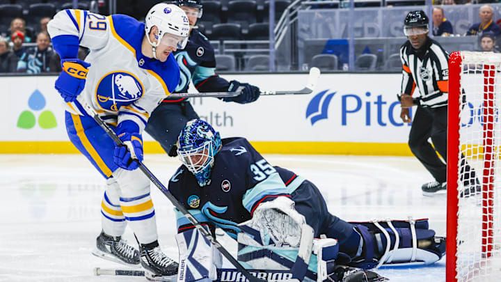 Jan 20, 2025; Seattle, Washington, USA; Seattle Kraken goaltender Joey Daccord (35) makes a save on a shot attempt by Buffalo Sabres left wing Beck Malenstyn (29) during the second period at Climate Pledge Arena. Mandatory Credit: Joe Nicholson-Imagn Images