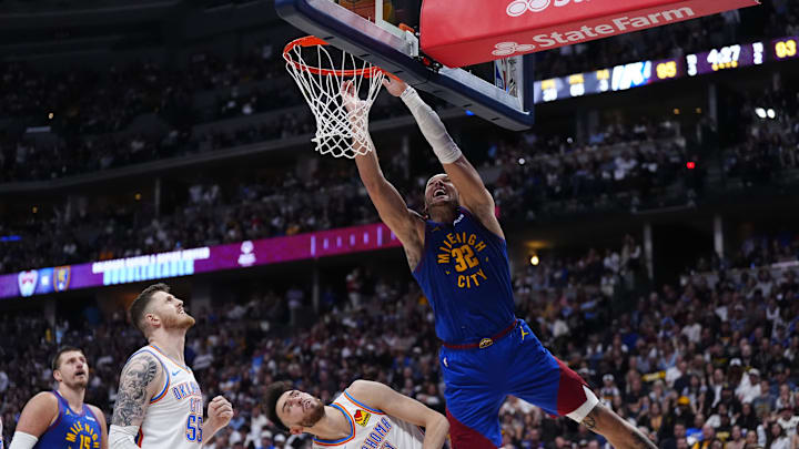 Oklahoma City Thunder center Isaiah Hartenstein (55) and forward Chet Holmgren (7) defend on Denver Nuggets forward Aaron Gordon (32) in the second half during game three of the second round for the 2025 NBA Playoffs at Ball Arena. Mandatory Credit: Ron Chenoy-Imagn Images