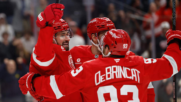 Mar 28, 2026; Detroit, Michigan, USA;  Detroit Red Wings center Dylan Larkin (71) receives congratulations from teammates after scoring in the second period against the Philadelphia Flyers at Little Caesars Arena. Mandatory Credit: Rick Osentoski-Imagn Images