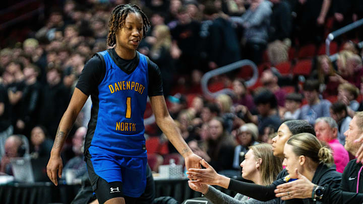 Davenport North's Divine Bourrage (1) high fives her teammates as she's subbed out during the third quarter of the Class 5A quarterfinal on Monday, March 3, 2025, at Wells Fargo Arena. Davenport North's Divine Bourrage (1) high fives her teammates as she's subbed out during the third quarter of the Class 5A quarterfinal on Monday, March 3, 2025, at Wells Fargo Arena.