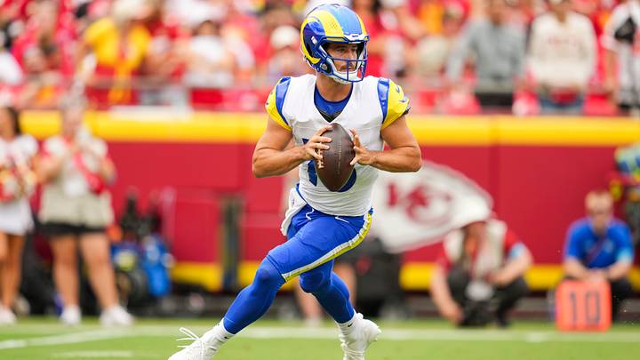 Aug 15, 2026; Kansas City, Missouri, USA; Los Angeles Rams quarterback Stetson Bennett IV (13) rolls out to pass during the first half against the Kansas City Chiefs at Arrowhead Stadium. Mandatory Credit: Jay Biggerstaff-Imagn Images