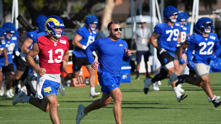 Jul 23, 2025; Los Angeles, CA, USA; Los Angeles Rams coach Sean McVay runs with quarterback Stetson Bennett (13) during training camp at Loyola Marymount University. Mandatory Credit: Kirby Lee-Imagn Images
