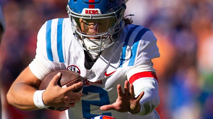 Mississippi Rebels quarterback Jaxson Dart (2) scramble during the second half as Florida Gators defensive back Bryce Thornton (18) tracks him at Ben Hill Griffin Stadium in Gainesville, FL on Saturday, November 23, 2024. The Gators defeated the Rebels 24-17 [Doug Engle/Gainesville Sun]