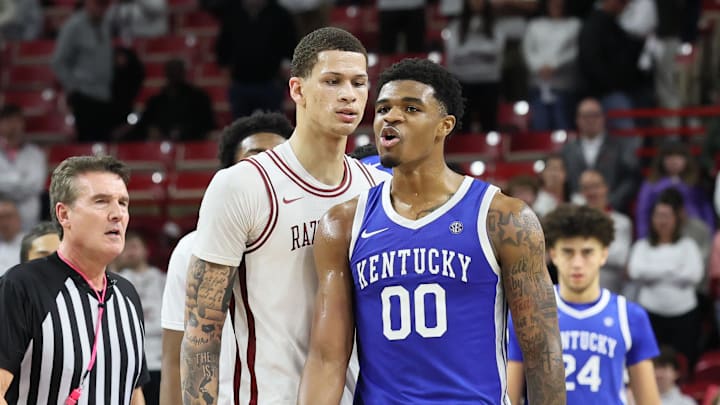 Jan 31, 2026; Fayetteville, Arkansas, USA; Arkansas Razorbacks forward Trevon Brazile (7) and Kentucky Wildcats guard Otega Oweh (00) exchange words during the second half at Bud Walton Arena. Kentucky won 85-77. Mandatory Credit: Nelson Chenault-Imagn Images