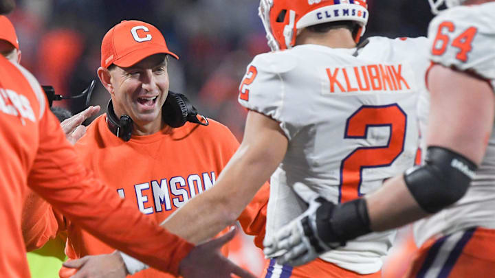 Dec 3, 2022; Charlotte, NC, USA; Clemson Tigers quarterback Cade Klubnik (2) celebrates with head coach Dabo Swinney  after scoring a touchdown against the North Carolina Tar Heels during the second quarter of the ACC Championship game at Bank of America Stadium. Mandatory Credit: Ken Ruinard-USA TODAY NETWORK