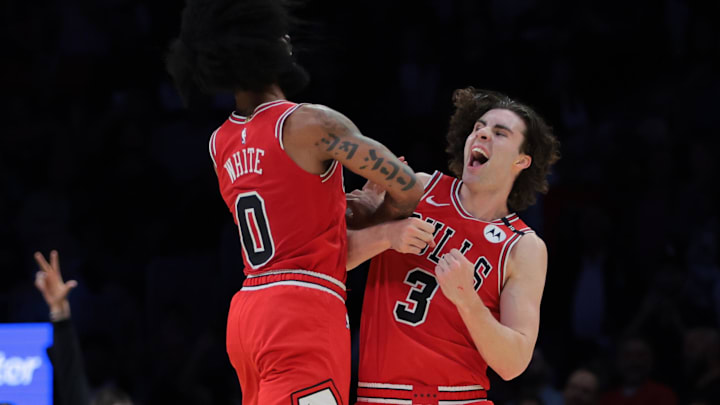 Mar 8, 2025; Miami, Florida, USA; Chicago Bulls guard Josh Giddey (3) celebrates with guard Coby White (0) after scoring against the Miami Heat during the fourth quarter at Kaseya Center. Mandatory Credit: Sam Navarro-Imagn Images