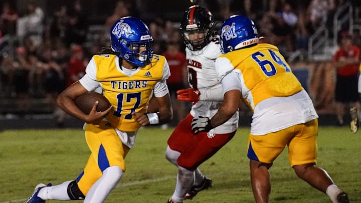 Martin County quarterback Manny Louis, Jr. scrambles for a big gain against South Fork during the 41st edition of the Martin Bowl on Monday, October 14, 2024 in Stuart. The Tigers won 35-25.