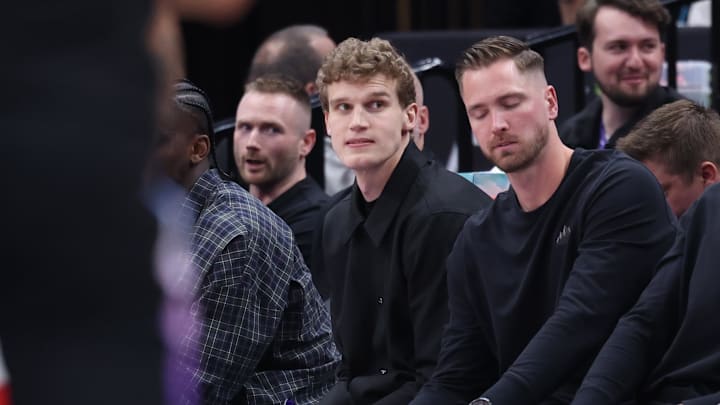 Mar 27, 2025; Salt Lake City, Utah, USA; Utah Jazz forward Lauri Markkanen (center) watches the game from the bench during the second half of the game against the Houston Rockets at Delta Center. Mandatory Credit: Rob Gray-Imagn Images
