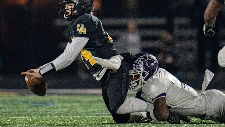 Nov 3, 2023; Upper Arlington, Ohio, USA;
Upper Arlington's Kyle Cox (14) is tackled by Pickerington Central's Myles Harrison (34) during their game on Friday, Nov. 3, 2023 at Upper Arlington High School for Division I Region 3 quarterfinal.