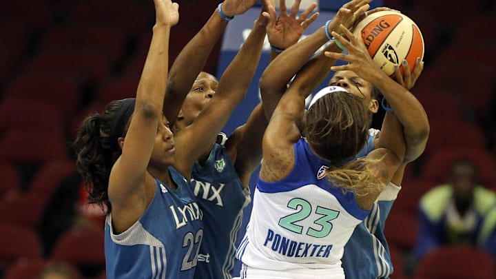 May 22, 2012; Newark, NJ, USA; New York Liberty guard Cappie Pondexter (23) is fouled by Minnesota Lynx defender Jessica Adair (1) (right) with coverage by Lynx defenders Monica Wright (22) and Taj McWilliams-Franklin (8) during the third quarter of a WNBA game at the Prudential Center. Mandatory Credit: Brad Penner-Imagn Images