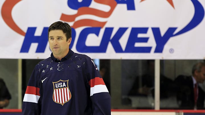 Aug 27, 2013; Arlington, VA, USA; Former  NHL player and Olympic team member Chris Drury walks onto the ice during a ceremony unveiling the 2014 Olympic hockey jersey as part of the 2013 U.S. men's national team camp at Kettler Capitals Iceplex. Mandatory Credit: Geoff Burke-Imagn Images