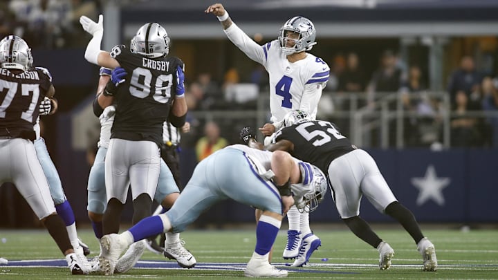 Nov 25, 2021; Arlington, Texas, USA; Dallas Cowboys quarterback Dak Prescott (4) throws the ball while pressured by Las Vegas Raiders linebacker Javin White (53) in the second quarter at AT&T Stadium. Mandatory Credit: Tim Heitman-Imagn Images