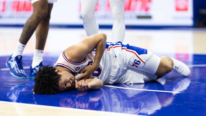 Oct 16, 2024; Philadelphia, Pennsylvania, USA; Philadelphia 76ers guard Jared McCain (20) reacts on the floor after being injured on a play against the Brooklyn Nets during the fourth quarter at Wells Fargo Center. Mandatory Credit: Bill Streicher-Imagn Images