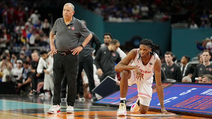 Houston coach Kelvin Sampson (left) and forward Joseph Tugler look on during the Cougars' NCAA Tournament title-game loss to Florida on April 7, 2025.