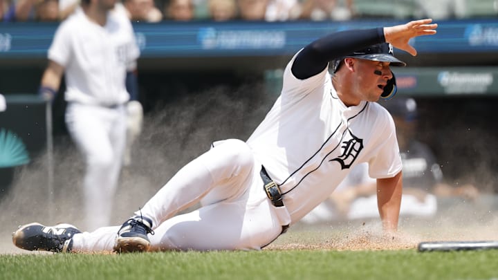 Jul 13, 2025; Detroit, Michigan, USA;  Detroit Tigers first baseman Spencer Torkelson (20) slides in safe at home in the first inning against the Seattle Mariners at Comerica Park. 