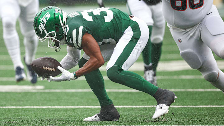 Sep 29, 2024; East Rutherford, New Jersey, USA; New York Jets cornerback Michael Carter II (30) recovers a fumbles in front of Denver Broncos center Luke Wattenberg (60) during the first half at MetLife Stadium. 
